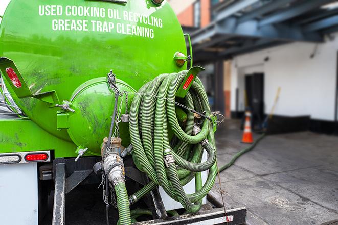 heavy-duty vacuum truck pumping out a grease trap in Bingham Farms, MI